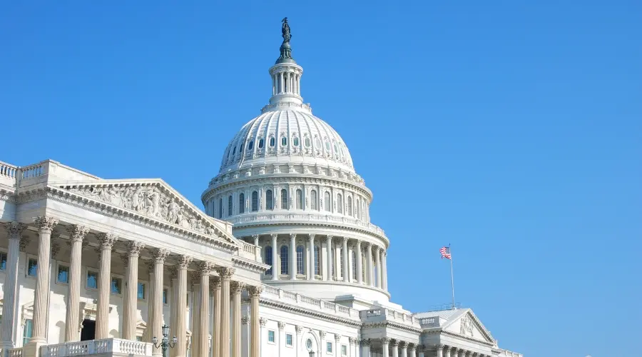 United States Capitol building under a clear blue sky.