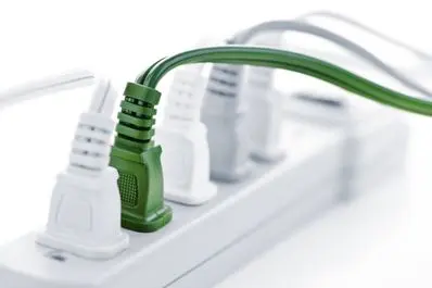 Multiple power cords plugged into an electric power bar