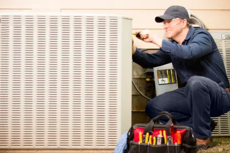 Technician performing maintenance on electrical equipment with tools nearby, emphasizing professional electrical services for home safety and efficiency.