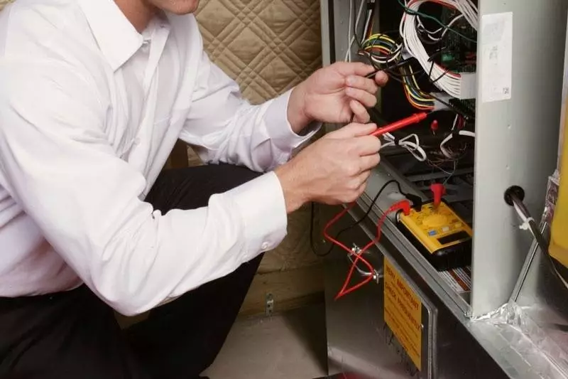 Technician working on a gas furnace