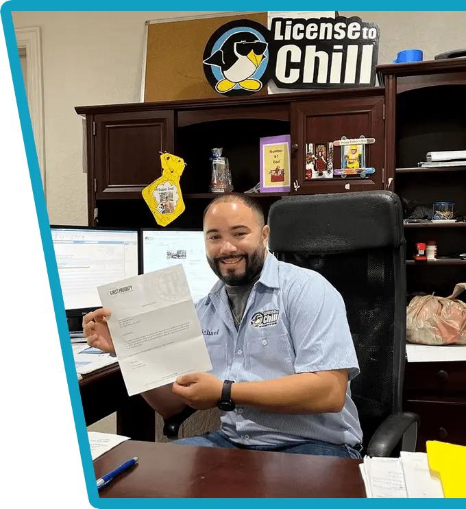 Smiling technician holding a letter in an office setting with "License to Chill" logo in the background, promoting HVAC services and customer communication.