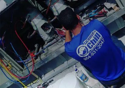 Technician from License to Chill working on HVAC unit, showcasing expertise in air conditioning repairs and maintenance services.