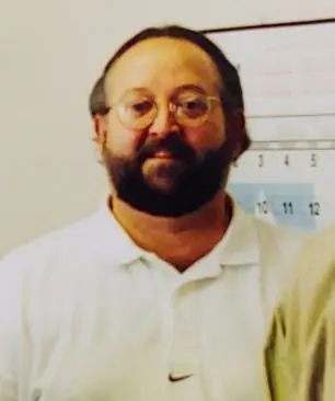 Rod Stuehm, 2nd generation HVAC professional, wearing a white polo shirt, with a calendar in the background, representing leadership at SOS Heating & Cooling.
