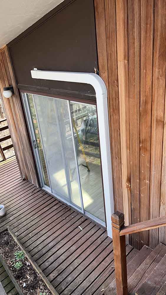 a wooden deck with a sliding glass door