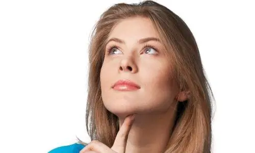 Woman contemplating plumbing options, emphasizing decision-making about water heater types.