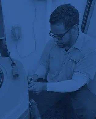 Easco Air Conditioning technician servicing HVAC equipment, demonstrating expertise in heating and cooling solutions for improved indoor air quality and energy efficiency.