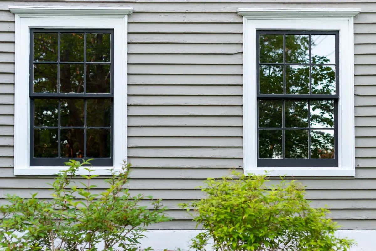 green gray house with white windows