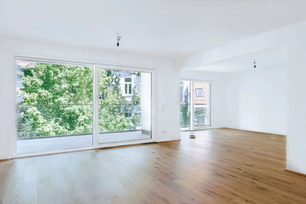 large empty living room with big windows