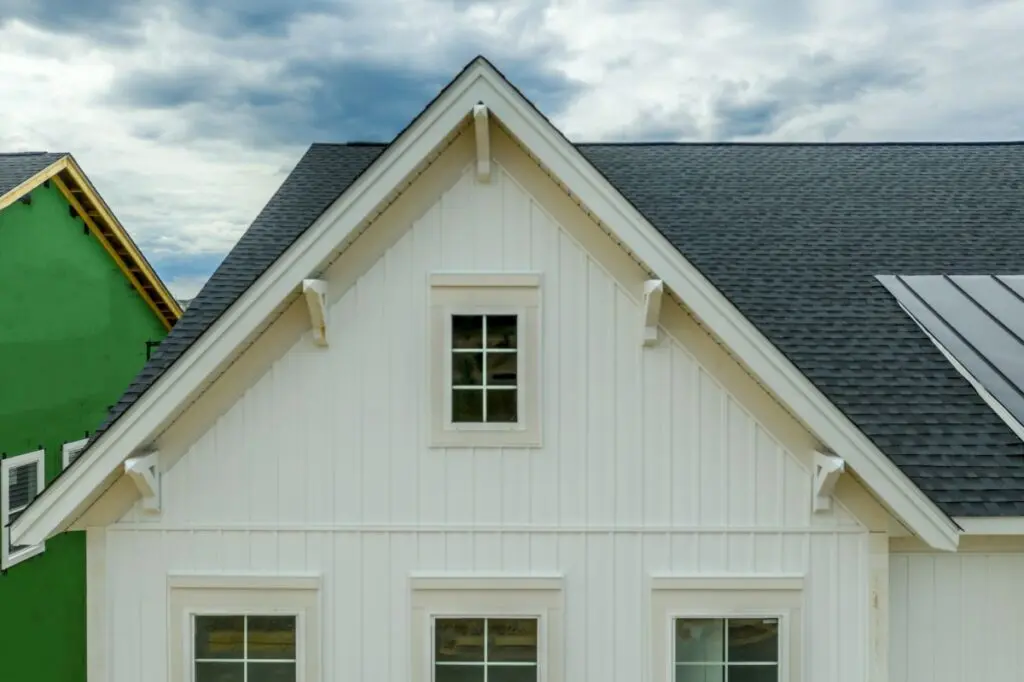 board and batten siding dark grey shingles white window