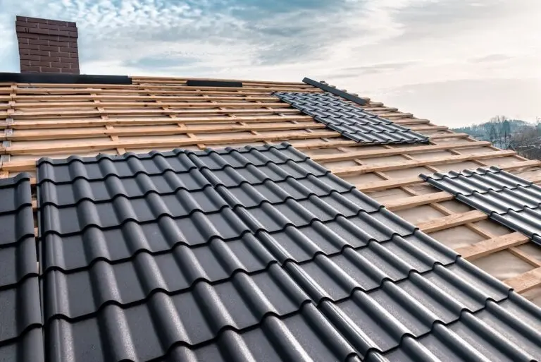 Metal tile on the roof. Roof repairing