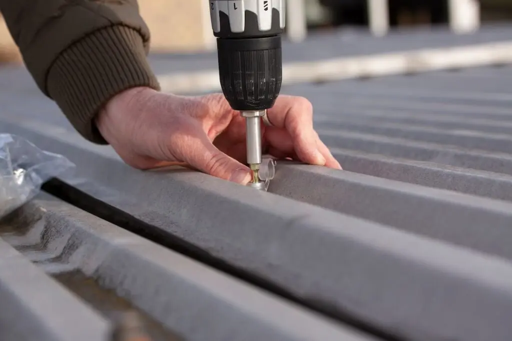 metal roof repair using a power drill and screws