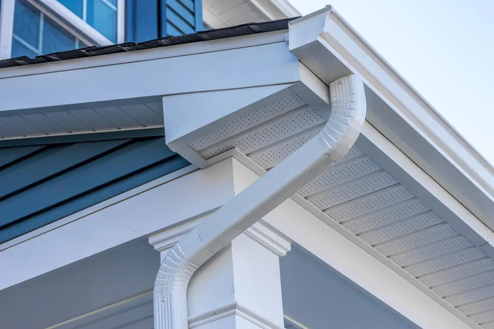 gutter colors-white gutters and roofing materials on blue sided house