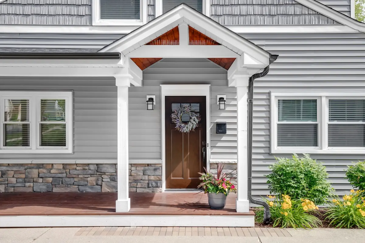 Vinyl siding on home with wood door