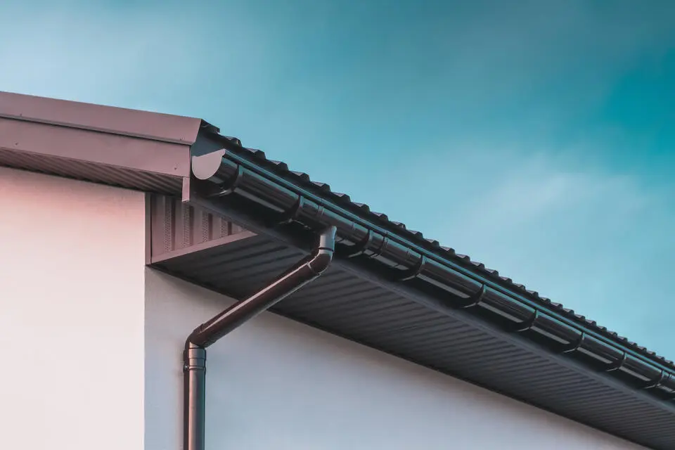 gutter colors-black gutters and roofing materials on white sided house