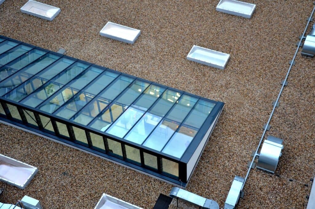 gravel mulch on roof of a flat green roof. covers and protects layers of insulation, decorative effect