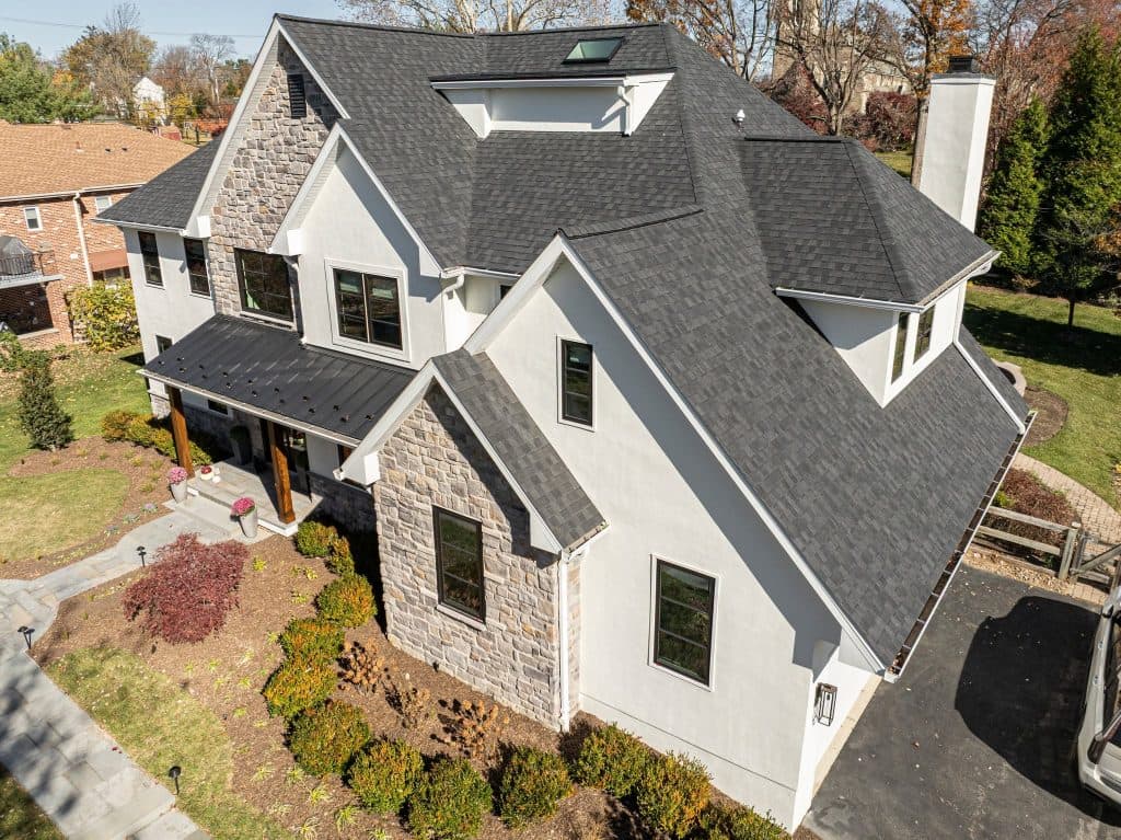 A grey shingle roof on a white house