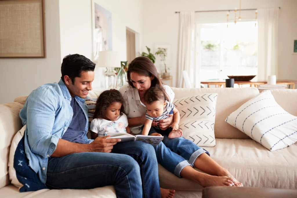 family of four sitting on couch