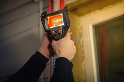 Professional water leak detection equipment revealing hidden moisture patterns behind a residential wall