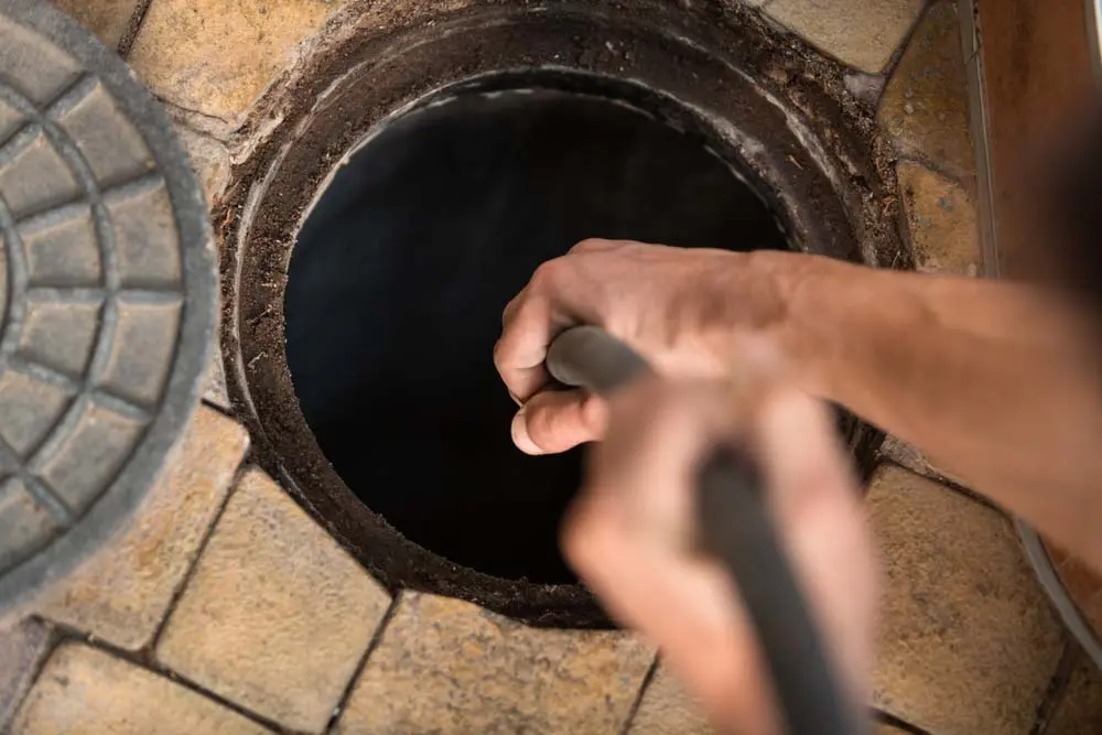 Sewer Surgeons technician hydro jetting a clogged drain