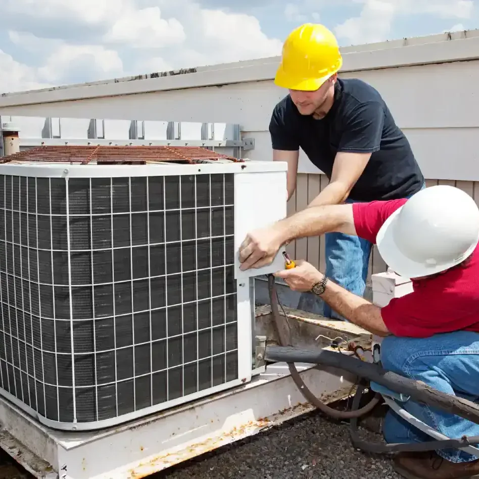 HVAC technicians repairing an air conditioner condenser unit in Bradenton & Sarasota, FL