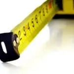 Bright yellow measuring tape with clear markings, ideal for plumbing maintenance during holiday preparations.