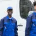 Two smiling plumbers in blue uniforms standing beside a service van, representing Allore's Plumbing Services and highlighting their friendly, professional team.