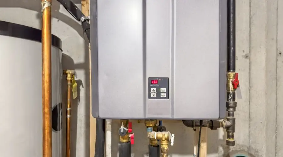 Tankless water heater installation with digital display and plumbing connections, showcasing energy-efficient hot water solution relevant to Allore's Plumbing Services.