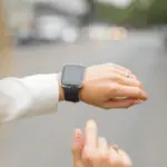 Smartwatch on a wrist, showcasing plumbing maintenance tips for homeowners during holidays by Allore's Plumbing Services.