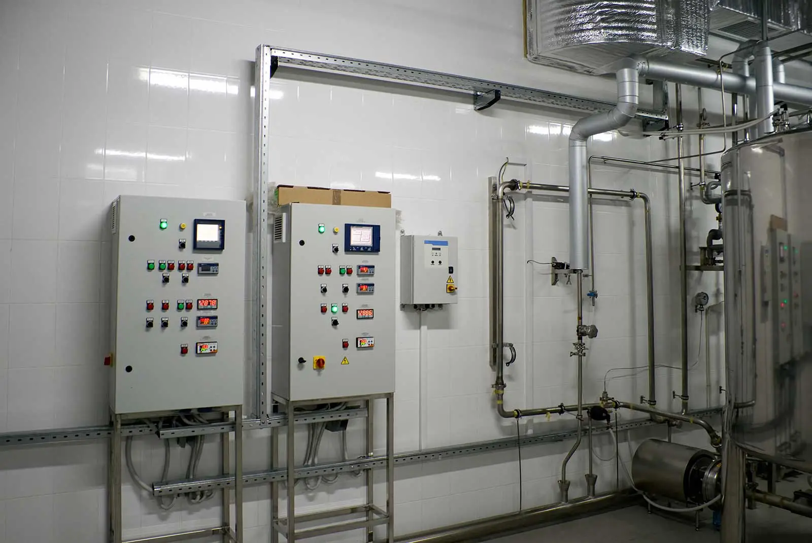 Control panels in a plumbing system, featuring buttons, screens, and piping for efficient operational management.