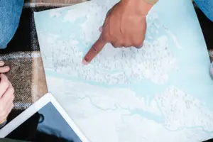 Map of plumbing service areas with a hand pointing to a specific location, showcasing Allore's Plumbing Services LLC's coverage and expertise.