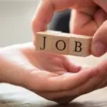 Hands presenting wooden blocks with letters "J", "O", and "B" representing job opportunities for Allore's Plumbing.