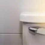 Modern toilet in minimalistic bathroom, showcasing clean surfaces for plumbing maintenance by Allore's Plumbing Services.