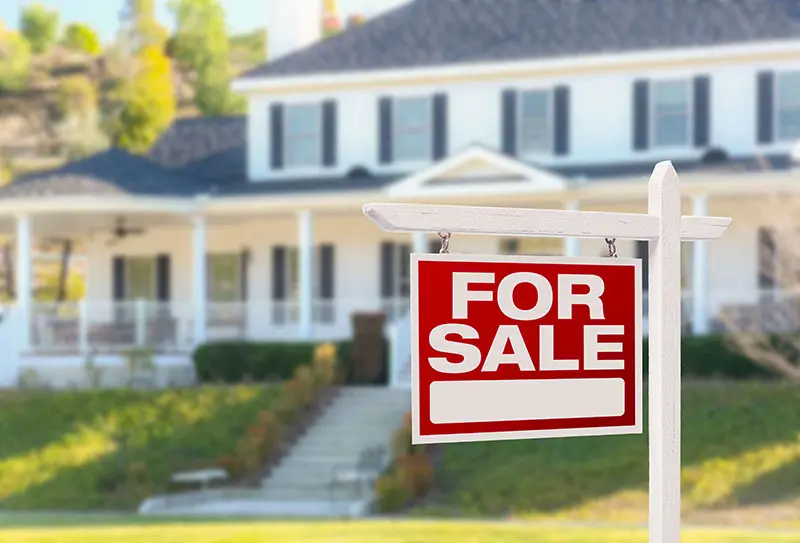 For sale sign in front of a house, highlighting real estate opportunities related to home services by Superior Plumbing, Heating & Air-Conditioning, Inc.