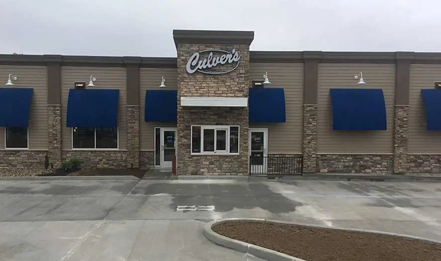 Culver's restaurant featuring stone architecture, blue awnings, and a well-maintained exterior by A & W Plumbing and Heating.