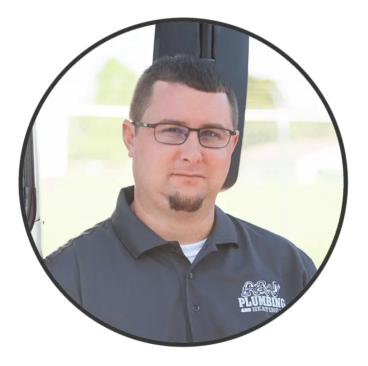 Ryan H., Project Manager and Estimator at A & W Plumbing and Heating, wearing a branded shirt, standing outdoors with a blurred background.