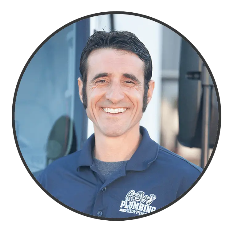 Smiling male technician in A & W Plumbing and Heating uniform, showcasing friendly service and expertise in plumbing and heating.
