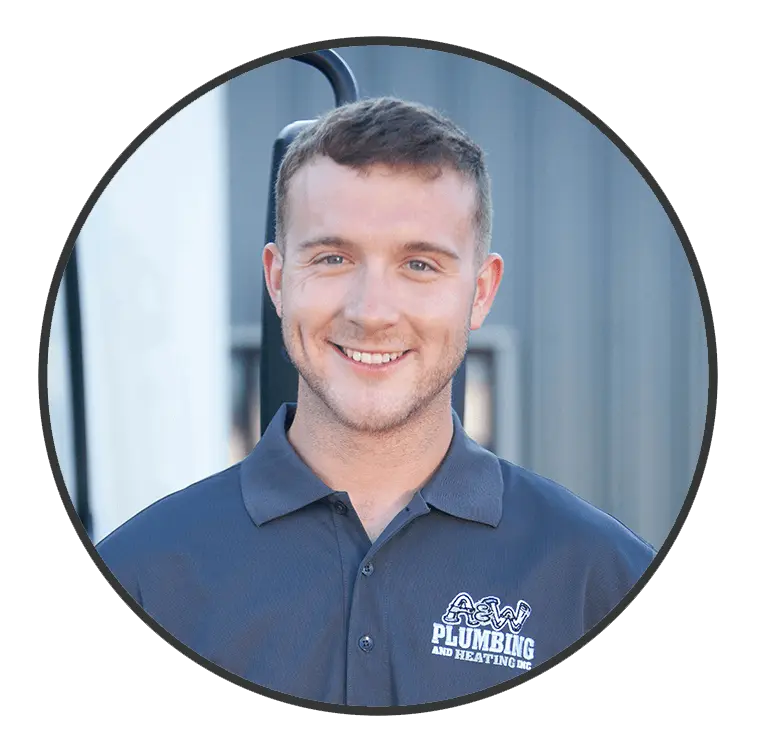 Smiling plumber from A & W Plumbing and Heating, Inc. wearing a branded shirt, showcasing professionalism and approachability.