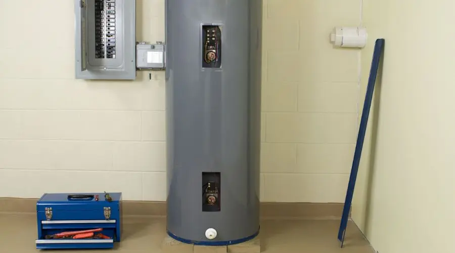 Utility area featuring a gray water heater, electrical panel, and blue toolbox for plumbing maintenance.