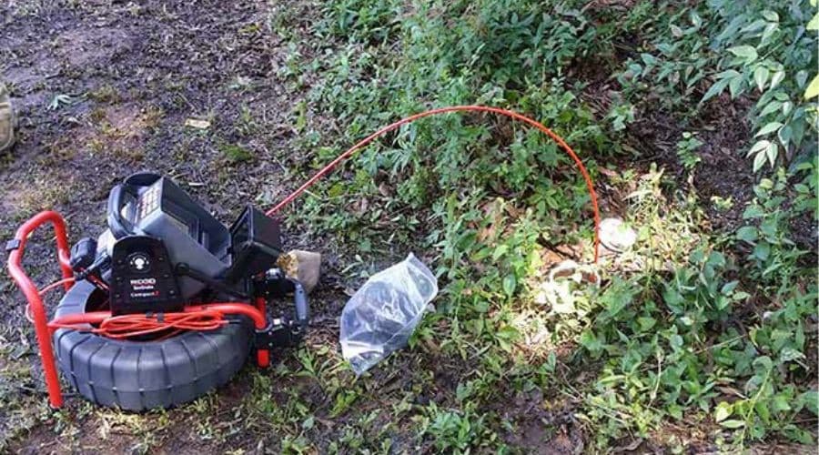 Plumbing inspection camera system on coiled cable in outdoor setting, A & W Plumbing and Heating, Inc. service.