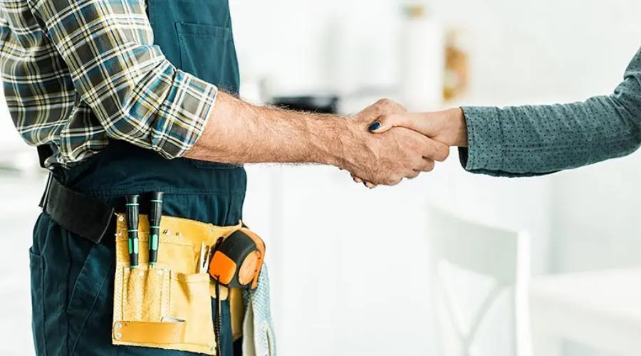 Tradesperson and client shaking hands, representing plumbing services by A & W Plumbing and Heating, Inc.