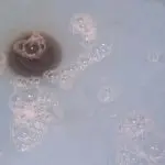 Brownish water with bubbles and foam indicating drainage issues in a sink or tub, reflecting the need for professional plumbing services like hydro jetting from A & W Plumbing and Heating, Inc.