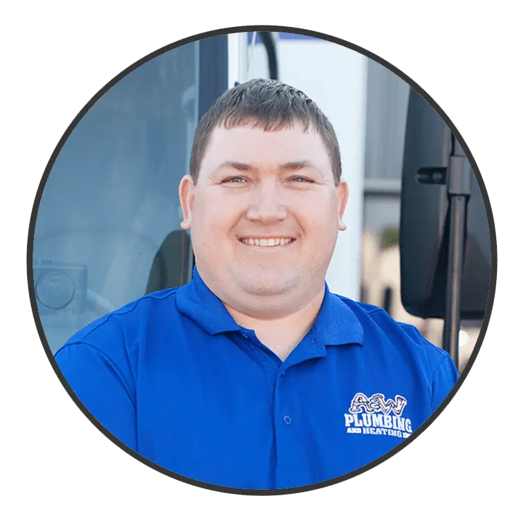 Smiling technician in blue A & W Plumbing and Heating shirt, showcasing friendly service and expertise in plumbing and heating.