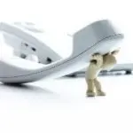 A small figure lifting a telephone receiver, illustrating challenges in plumbing and HVAC by B & D Plumbing, Heating & A/C.