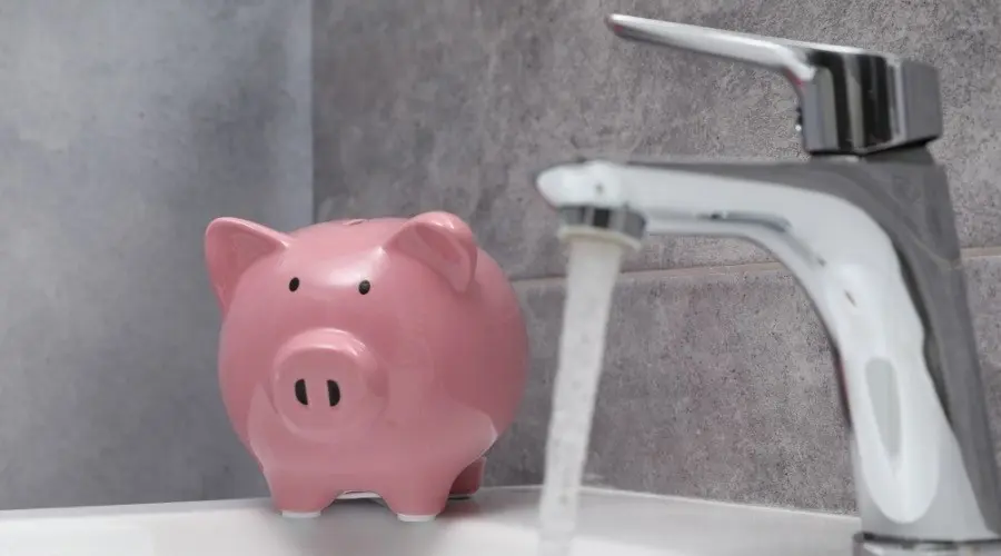 Water flowing from faucet and filling pink piggy bank, illustrating water-saving practices.
