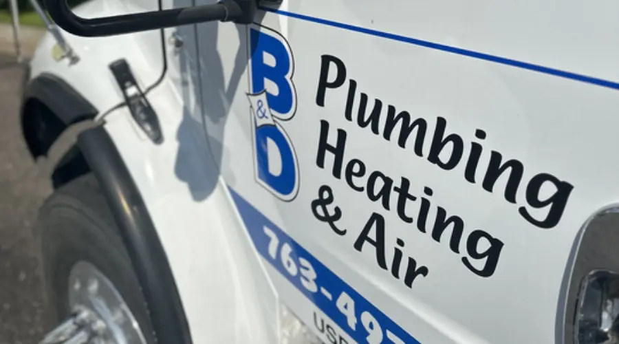 B&D Plumbing, Heating & A/C service vehicle displaying branding, logo, and contact information on a vehicle.