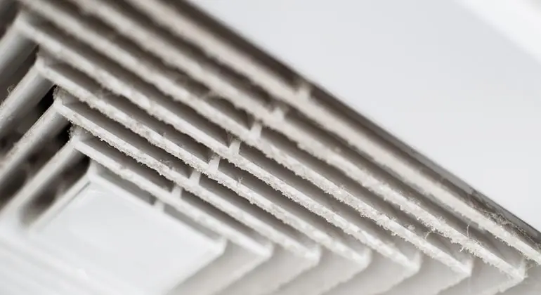 Dirty HVAC air vent highlighting the importance of duct blaster testing for improved energy efficiency and indoor air quality.