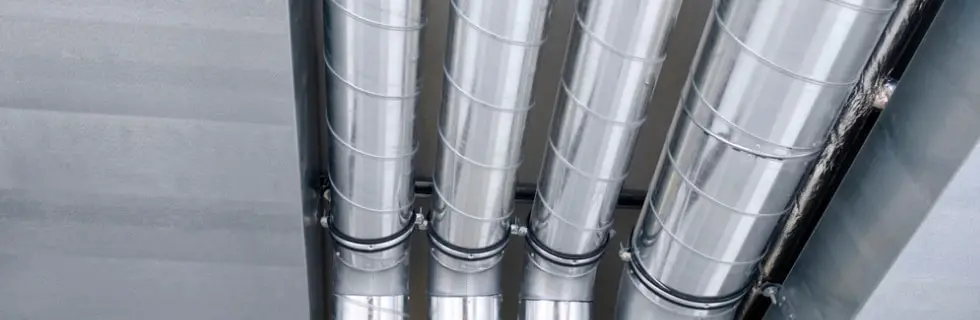 Metal air ducts in a ceiling, showcasing HVAC system components for improved indoor air quality and system efficiency.