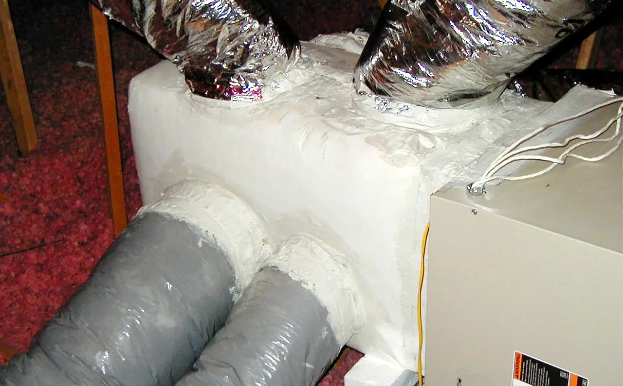 Ductwork installation with insulated gray ducts and metal connectors, highlighting HVAC system components for improved airflow and indoor air quality in Austin homes.