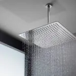 Modern square showerhead in sleek Austin bathroom, featuring even water flow for a refreshing experience.