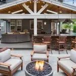 Outdoor seating area with a fire pit and wooden furniture, perfect for gatherings by A-Plus Air Conditioning.